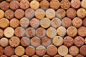 Abstract background of used wine corks with corkscrew