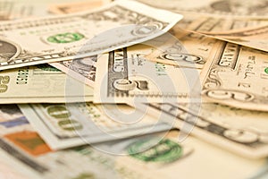 Abstract background of various dollar bills. Selective focus