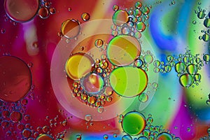 Abstract background with vibrant colours. Oil drops in water. Close colorful and artistic bubbles. Space pattern
