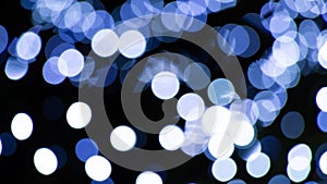 Abstract background of white and blue light halos or circles in a tree