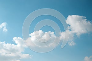 Abstract background of light blue sky and diagonal fluffy cloud.