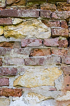 Abstract backgrounds: ancient ruined red brick wall with lime stones
