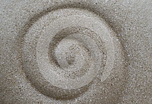 Abstract backgrounds of spiral design by hand on the white sand beach