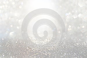 Abstract backgrounf of glitter vintage lights . silver and white. de-focused photo