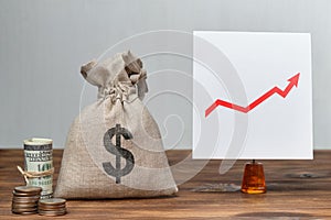 Abstract bag with money and a us dollar sign next to a white sticker. Business growth concept