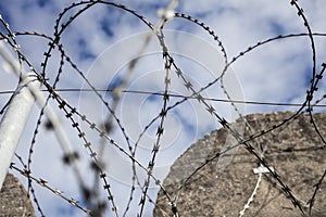Abstract barbed wire detail of strong topwith straight concrete