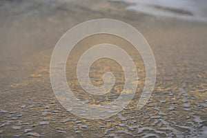 Abstract beach scene with sea water foam patterns on the shore.