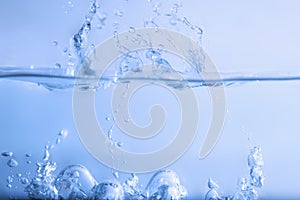 Abstract beautiful blue water splash with bubbles background