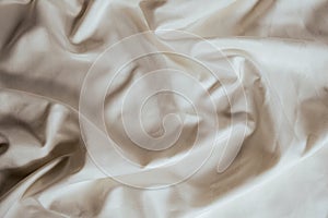 Abstract beige fabric background, satin stripe texture, wavy folds of elegant expensive fabric