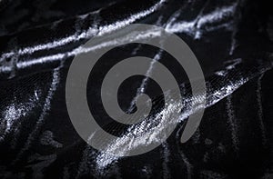 Abstract black creasy velvet fabric background texture