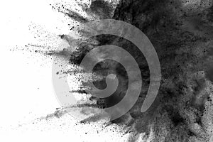 Abstract black dust explosion on white background.