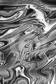 Abstract black and white image of spilled oil paint Vertcial