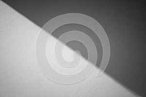 Abstract Black and White image of sunlight shading shadow on white concrete wall at outside of buildings.