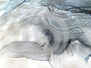 Abstract blue background with gray and gold. Alcohol ink art. Blue fluid texture resembles sea, watercolor or aquarelle.