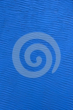 Abstract blue background with rough texture. Painted texture wall close up. Vertical frame