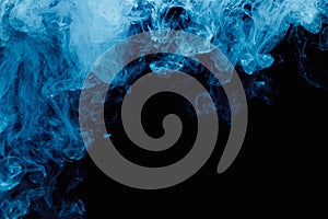 Abstract blue cloud pattern of white smoke on a black background.