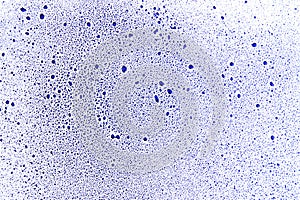Blue drops and blobs on a white surface