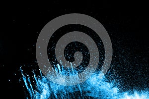 Abstract blue dust explosion on black background