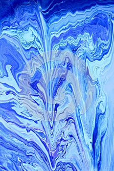 Abstract blue marble background. The effect of natural stone. Acrylic paint flows freely and creates an interesting pattern.