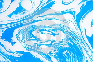 Abstract blue marble background. Stains of paint on the water.