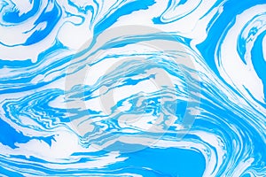 Abstract blue marble background. Stains of paint on the water.