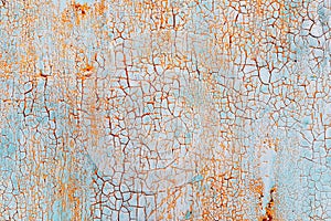 Abstract blue orange texture with grunge cracks. Cracked paint on a metal surface