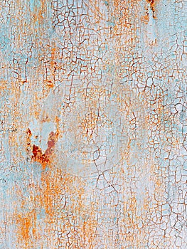 Abstract blue orange texture with grunge cracks. Cracked paint on a metal surface