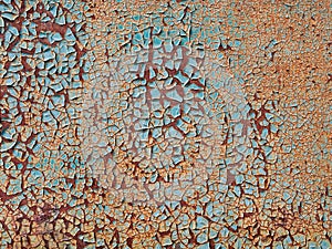 Abstract blue orange white texture with grunge cracks. Cracked paint on a metal surface. Bright urban background with rough paint