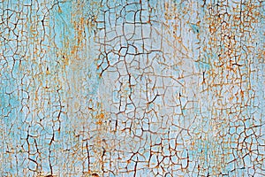 Abstract blue orange white texture with grunge cracks. Cracked paint on a metal surface. Bright urban background with rough paint