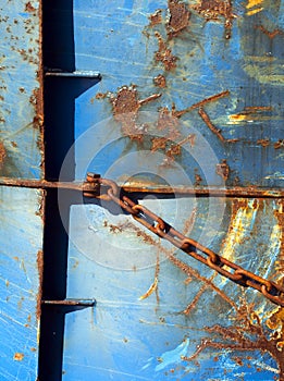 Abstract blue part of rusty sheep hull and metal chain