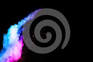 Abstract blue-pink dust explosion on  black background. abstract blue-pink powder splattered on dark  background