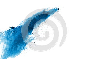 Abstract blue powder explosion on white background. Closeup of blue dust particles splash isolated on clear background