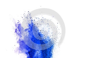 Abstract blue powder explosion on white background. Closeup of blue dust particles splash isolated on clear background