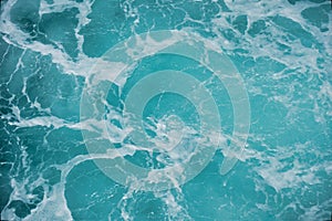 Abstract blue sea water with white foam for background