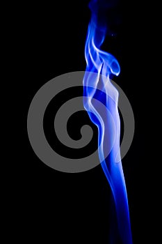 Abstract blue smoke swirls over black background