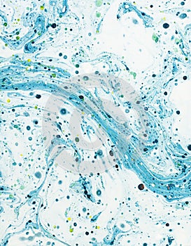 Abstract blue swirl background made from a can of paint.