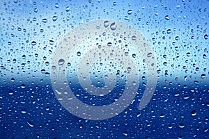 Abstract blue water dropsoin glass background