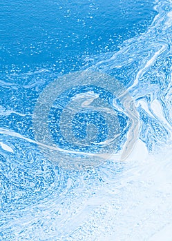 Abstract blue water swirling forming patterns.