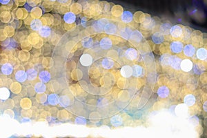 Abstract blur bokeh background with Christmas festive lights yellow and blue defocused illumination background