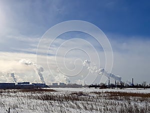 Abstract, blur, bokeh background, defocusing - image for the background. Winter landscape and smoke from a chemical plant.