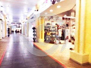 Abstract blur bokeh lights luxury shopping mall and department store interior. Blurred background with people in shopping mall wit