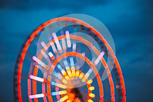 Abstract Blur Of Brightly Colorful Illuminated Ferris Wheel In Amusement City Park. Bokeh Boke Background