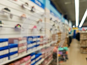 Abstract blur empty supermarket discount store aisle and product shelves interior defocused background