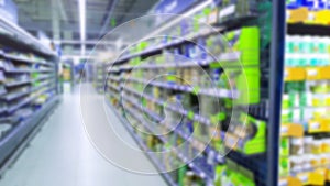 Abstract blur image of supermarket background. Defocused shelves with products. Grocery shopping. Store. Retail industry. Rack.