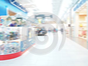 Abstract blur shelf in minimart and supermarket. Motion blurred customers walking in shopping mall