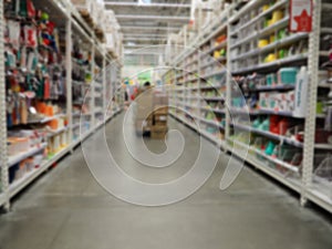 Abstract blur shelf in minimart and supermarket. Motion blurred customers walking in shopping mall