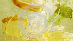 Abstract blur water surface motion, splash, ripples, lemon fruit and mint leaves