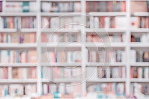 Abstract blurred background of bookshelves with books in library, book store. Concept of learning, school, education