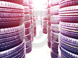 Abstract blurred background with car tires for sale. Blur photo of lots of car tires in the shop for sale. Car parts store bokeh b