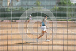 Abstract blurred background, girl playing tennis outdoors. Concept of sport